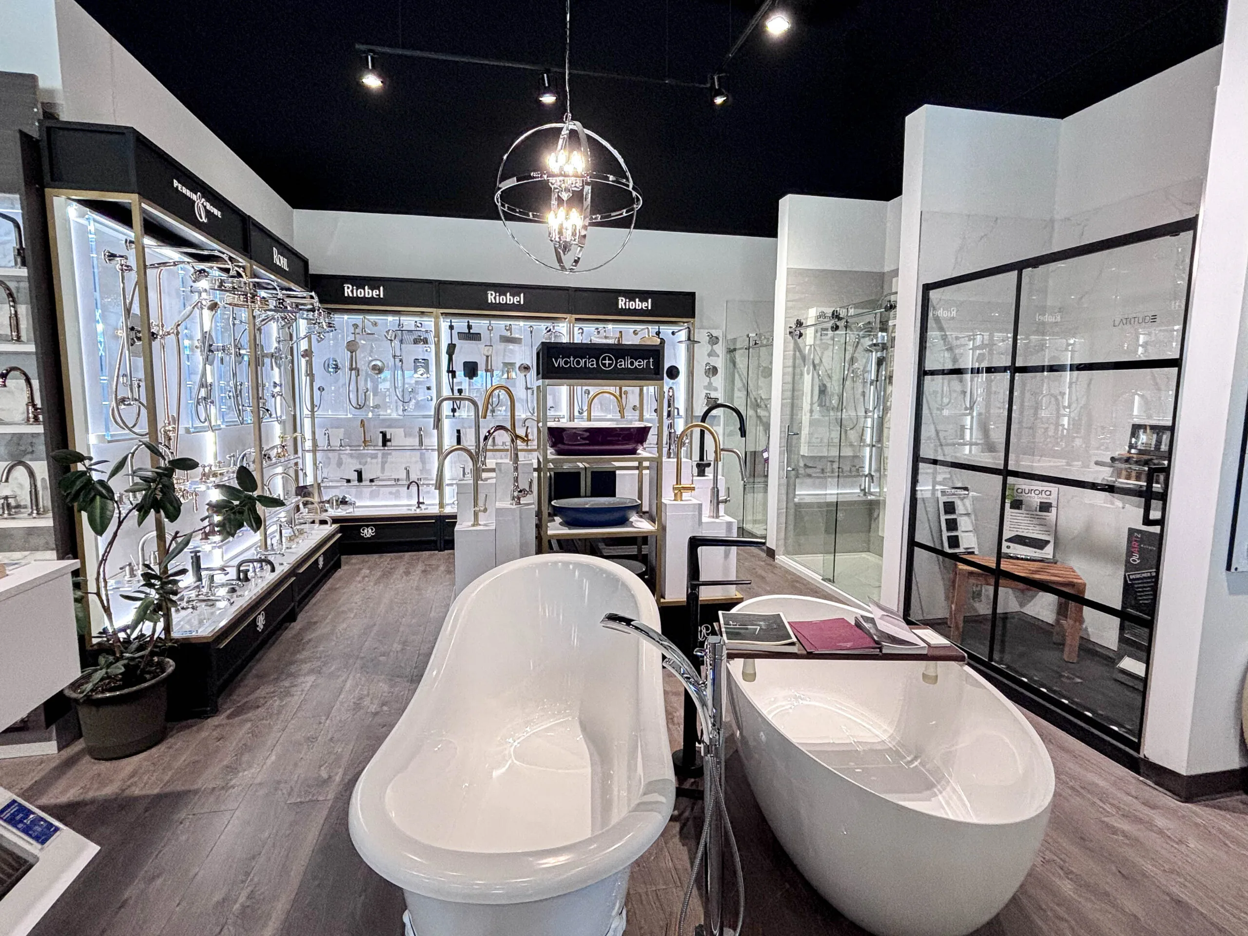 Showroom aisle with freestanding bathtubs and faucet display walls